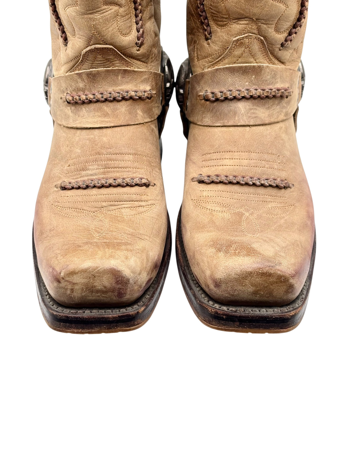 Beige cowboy boots front view with braided stitching detail and dark rubber sole