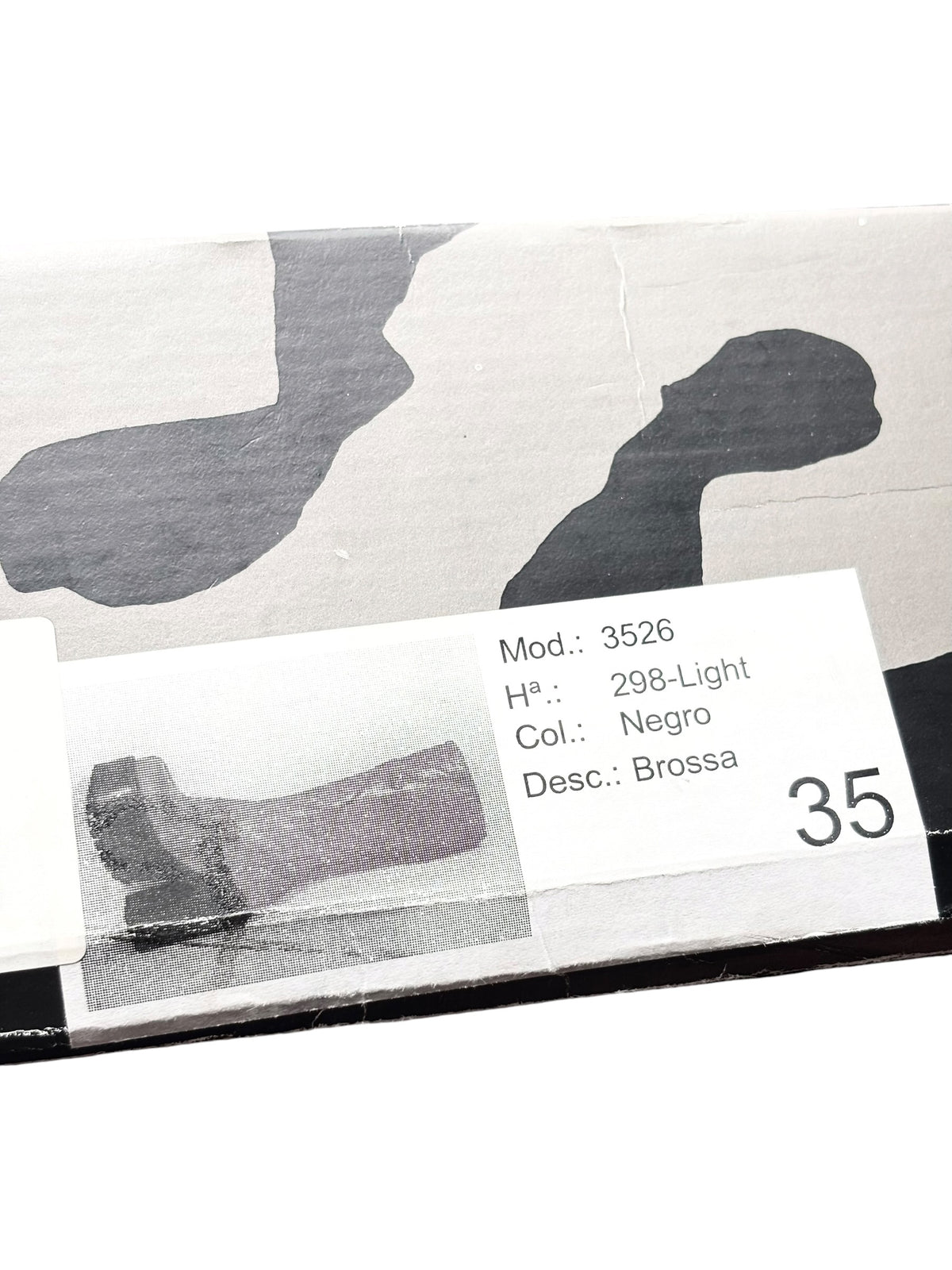 Black knee-high platform boots with size label on box