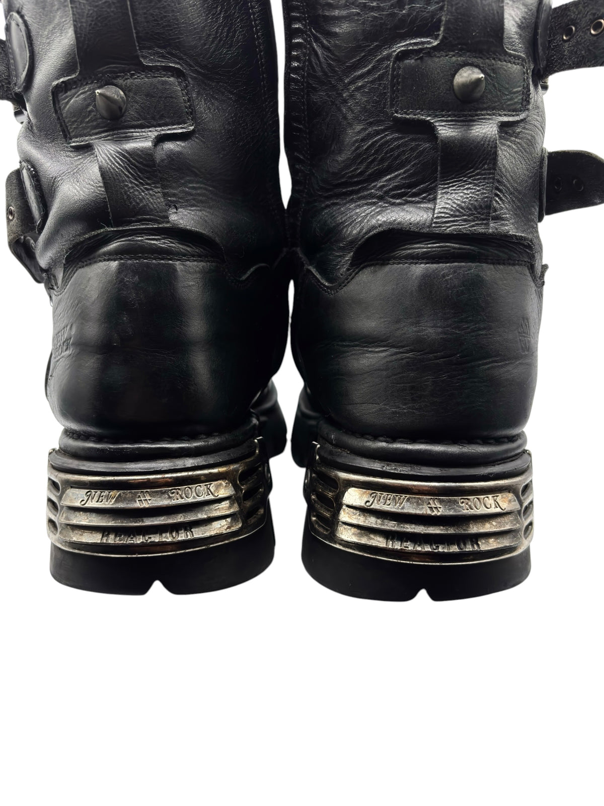 Studded leather platform boots, black finish, rear view with layered metal heel plates