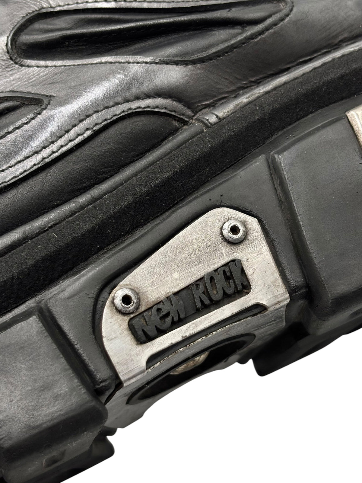 Black platform boot side panel with stitched seams and New Rock logo plate