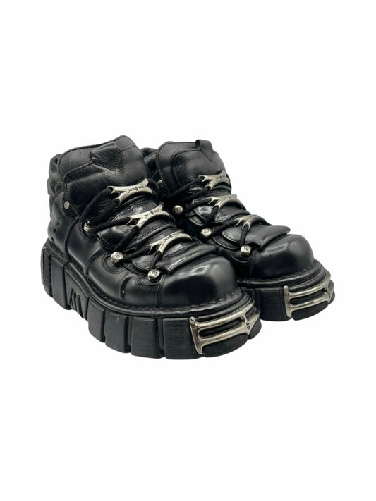 Black lace-up platform boots with thick platform sole and metal eyelets