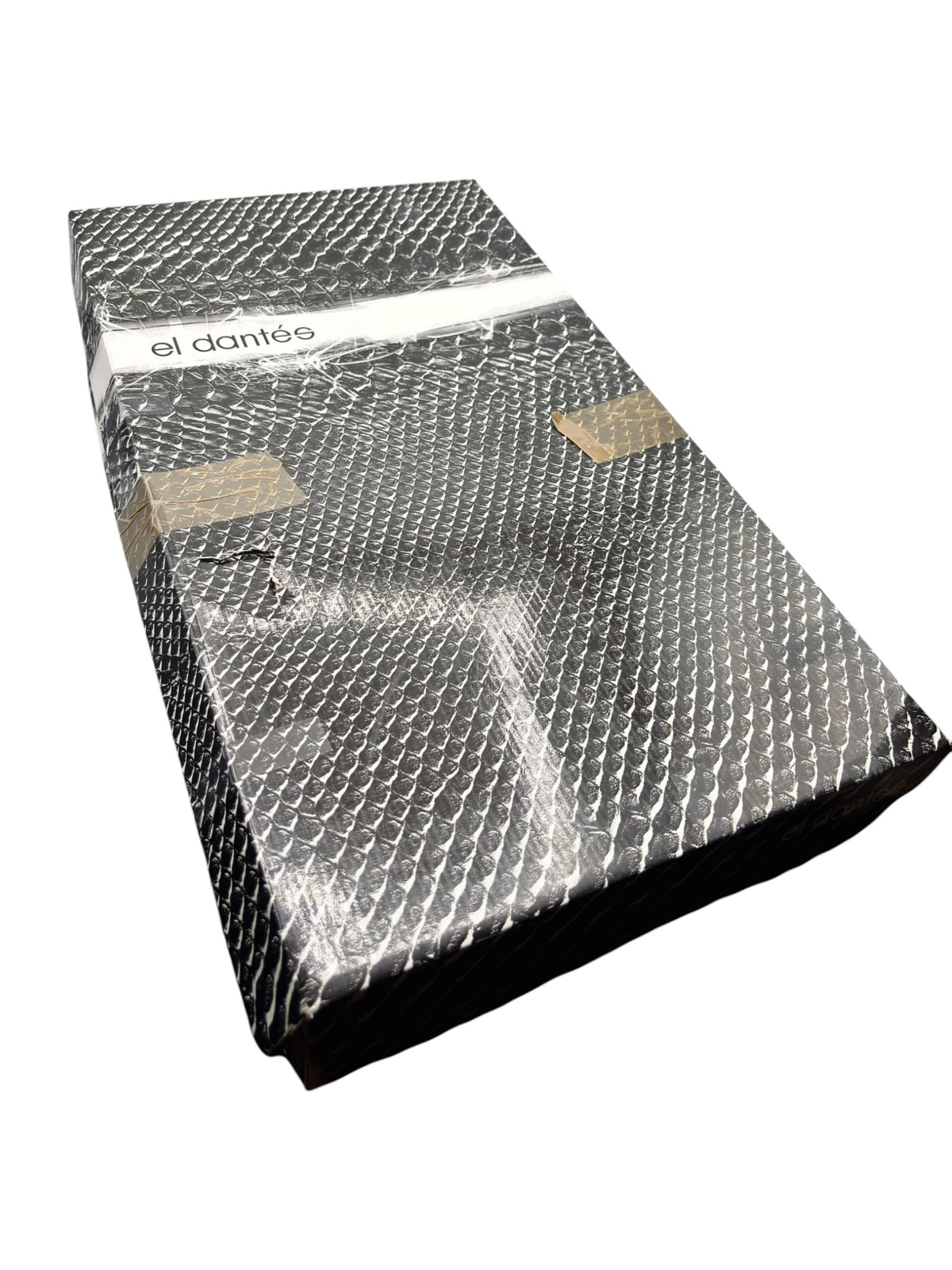El Dantes knee-high leather boots in silver protective packaging