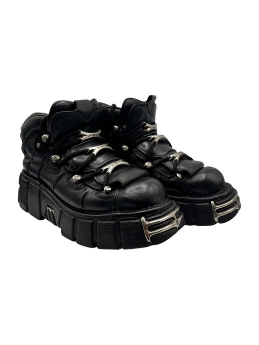 Black leather platform boots from angled front with silver toe and lace hardware