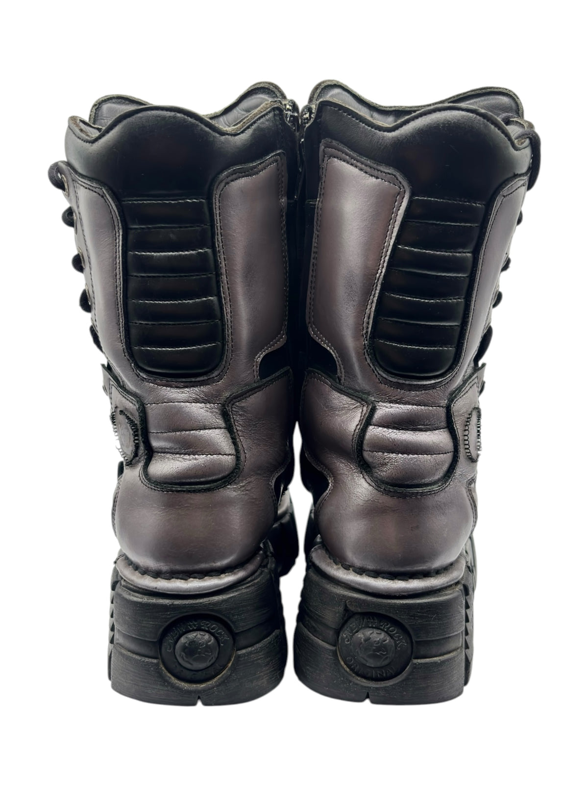 Back view of black platform boots with ankle cushioning, rounded heel, and tread blocks