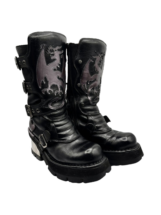 Angled view of black leather mid-calf boots with dragon relief panels and platform sole