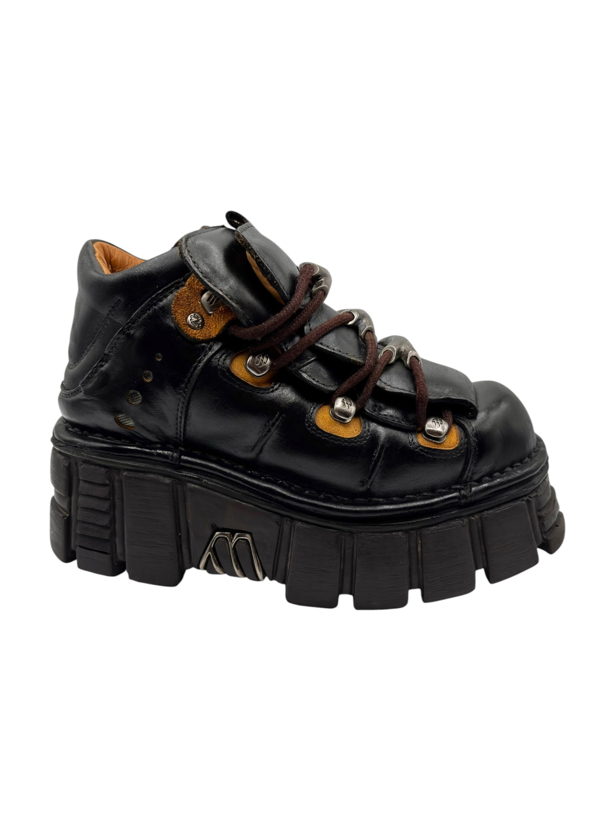 Black platform boot side view with lace-up closure and chunky outsole blocks.