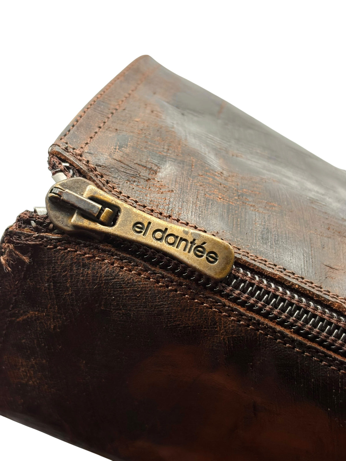 Close-up of boot upper with metal zipper pull and elda n te logo on leather