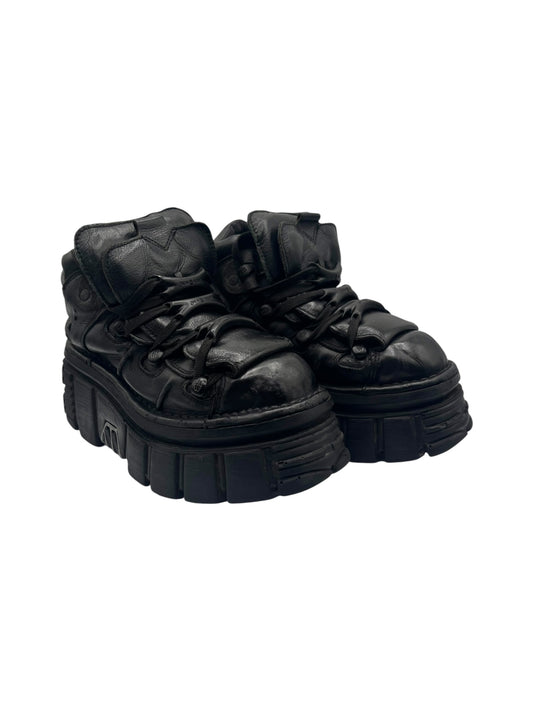Black lace-up platform boots, top view angle, showing laces and thick sole ridges.