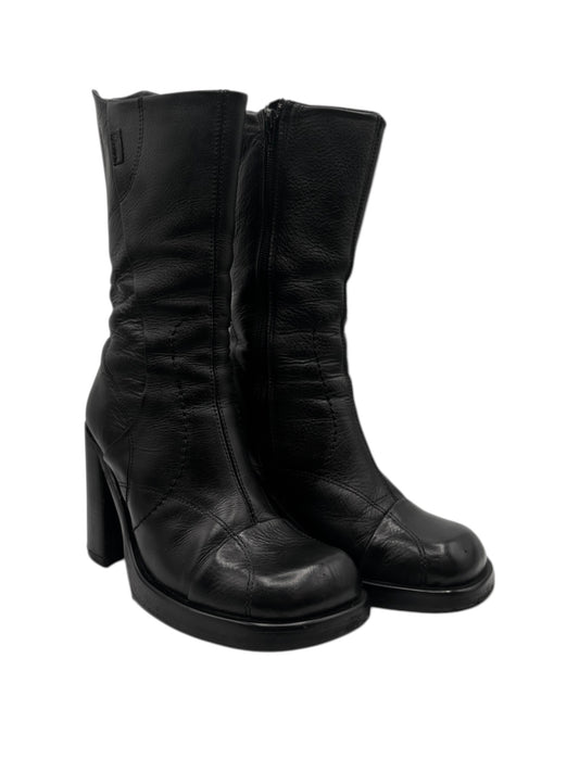 Black leather boots in 3/4 view with side zipper and chunky heel