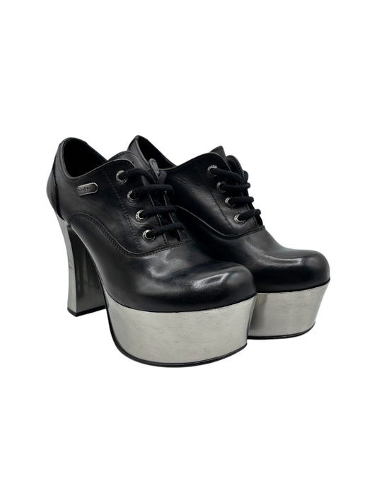 Black leather lace-up platform heels with tall block heel and silver-toned platform