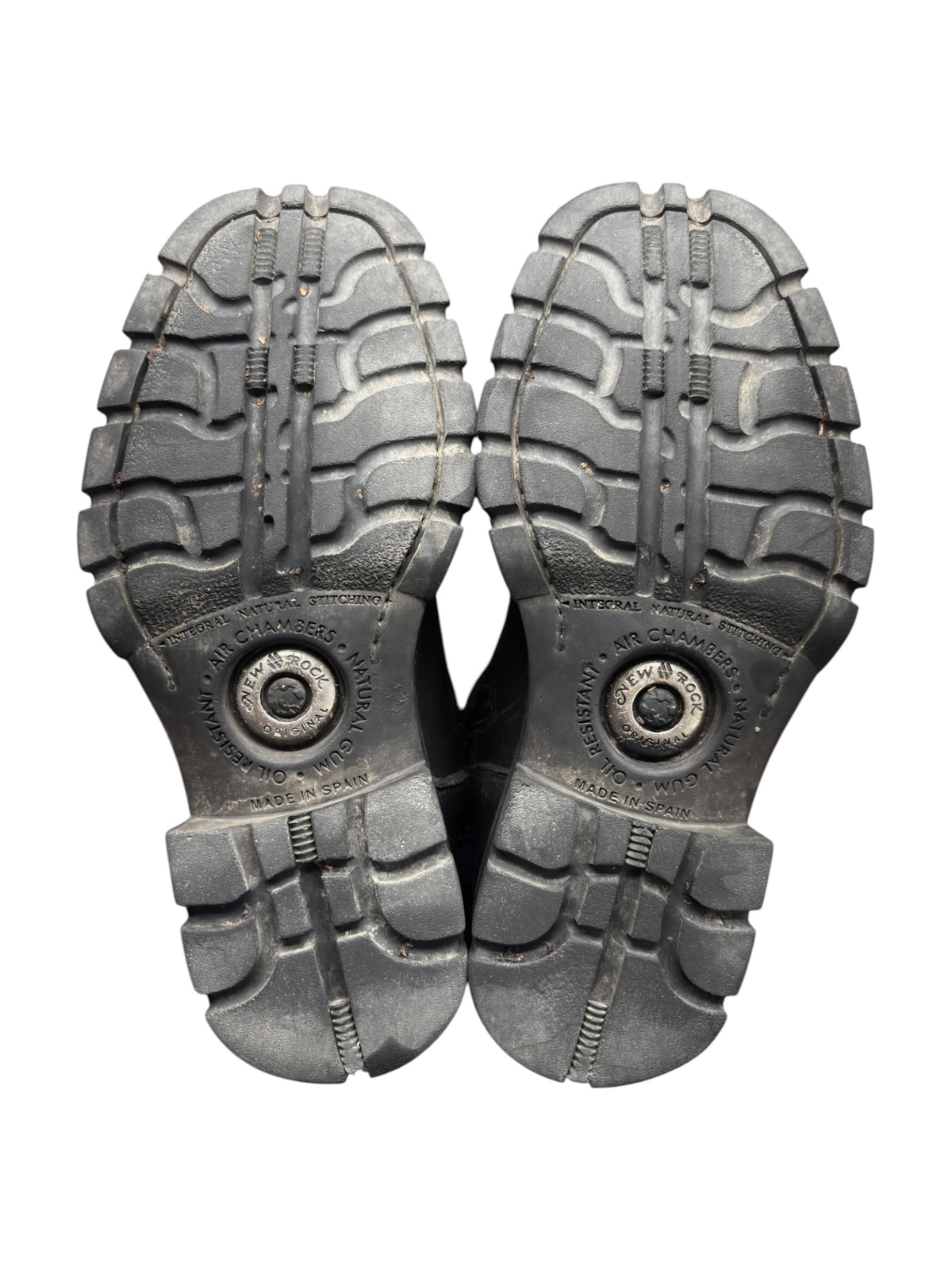Pair of black boot soles with deep tread and central brand medallion