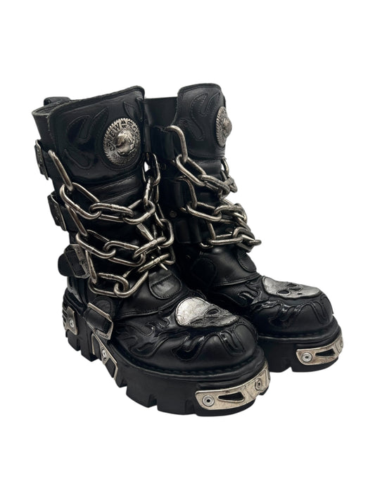 Dark leather combat boots with chain laces, round coin emblem, and metal side plates