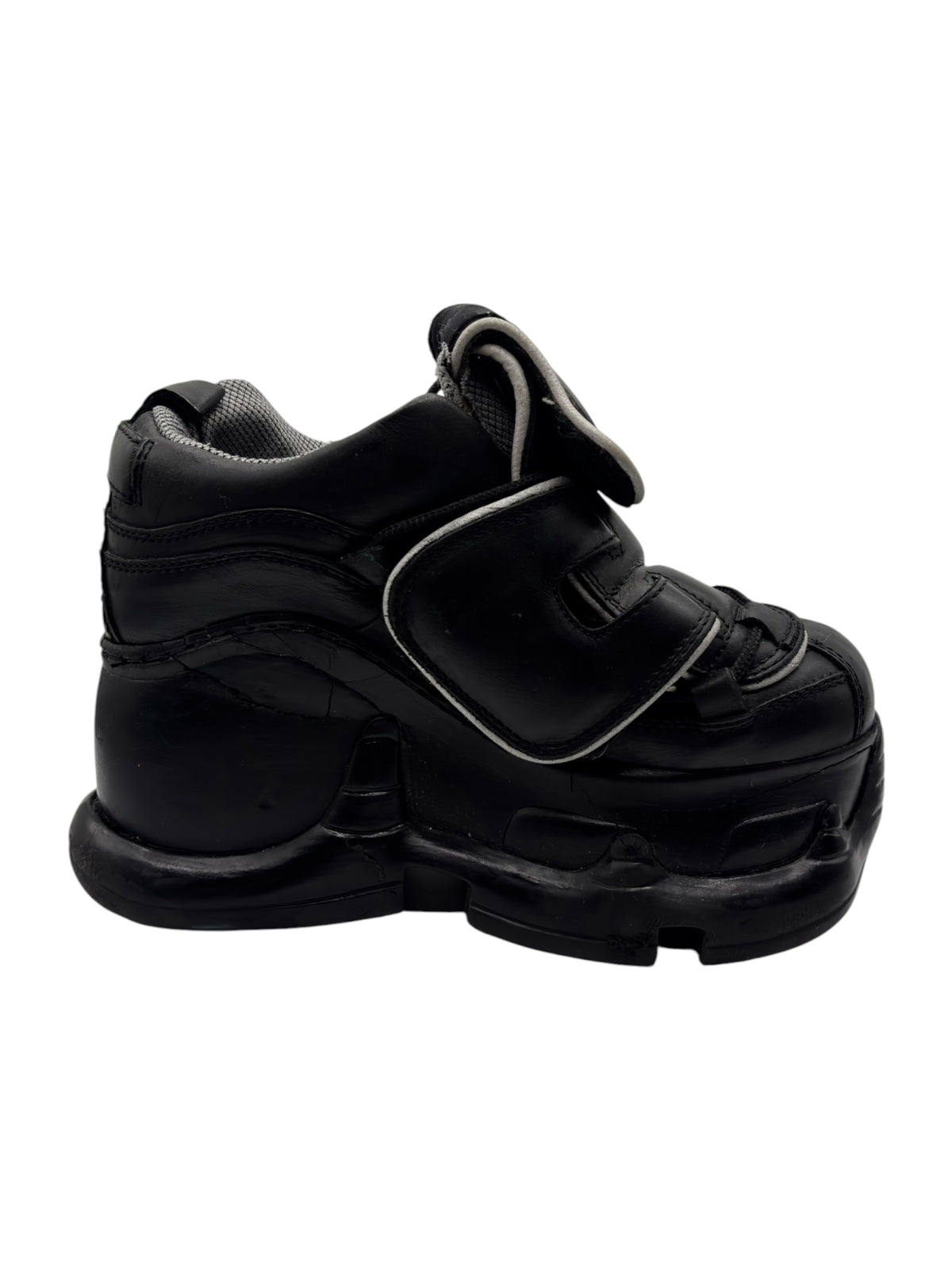 Black platform boots with side strap detail and thick tread sole, angled view.