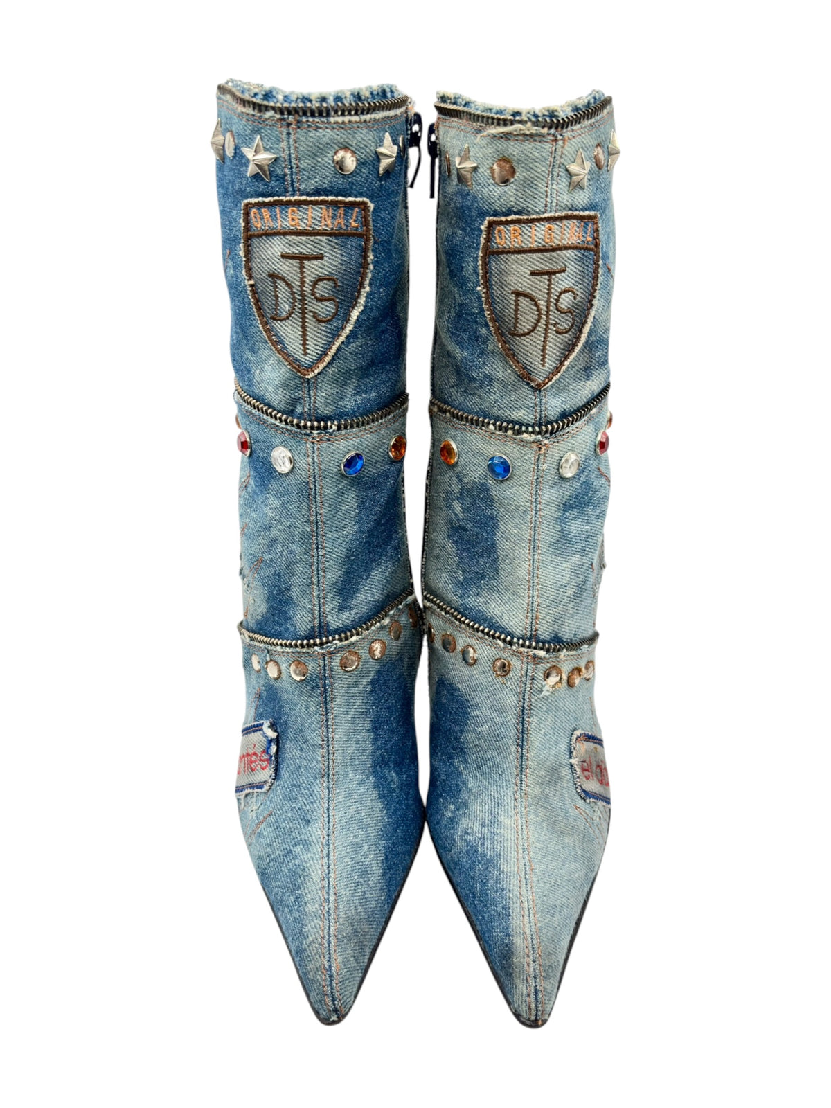 Mid-calf denim boots pair with tall shafts, stud bands, and crest patches on the back