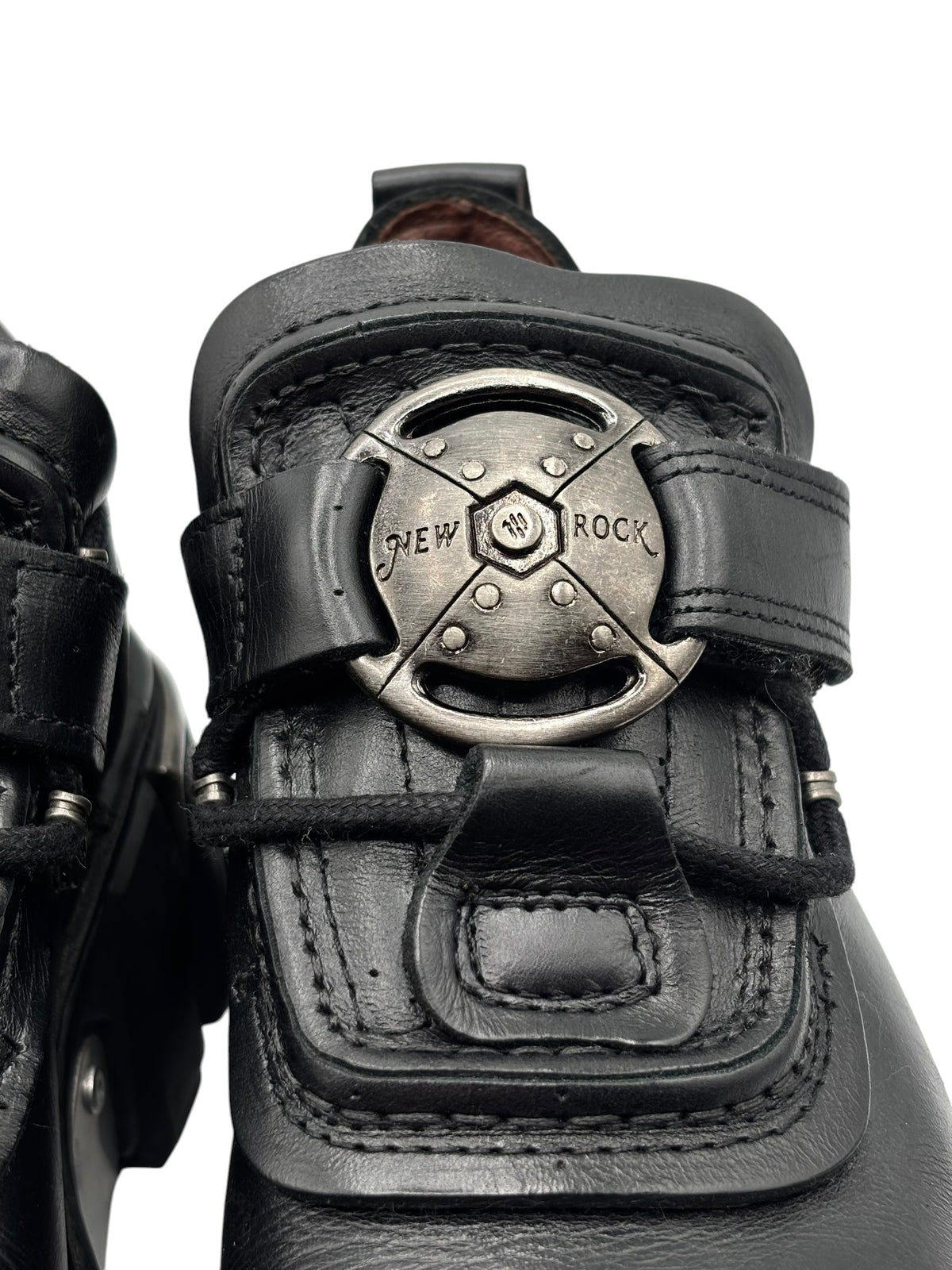 Close-up of New Rock platform boot strap with circular metal buckle and stitching