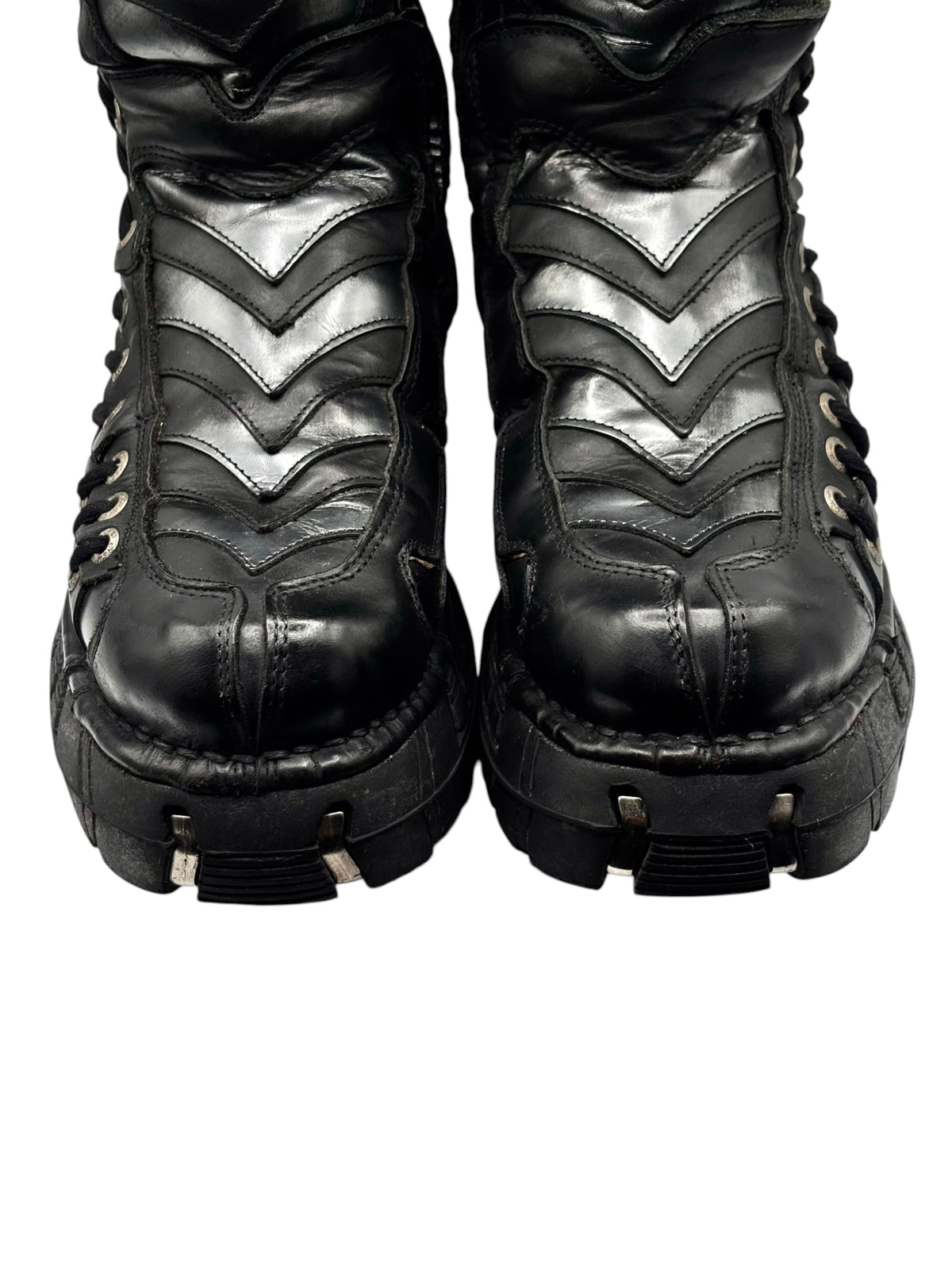 Black ankle boots with zigzag stitched panels and lace-up eyelets