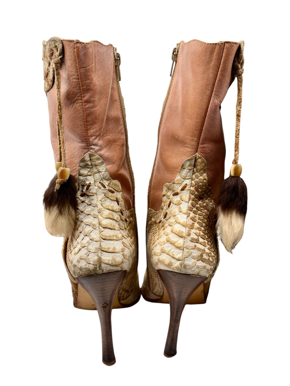 Pair of beige snake-pattern leather boots with tall shaft and faux-fur tassels