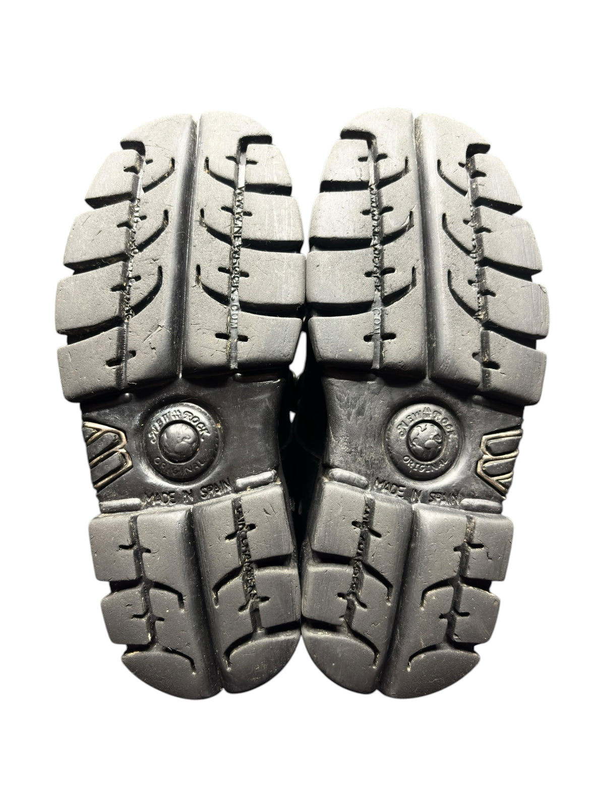 Vintage platform boots, pair of black rubber outsoles with studded tread pattern.