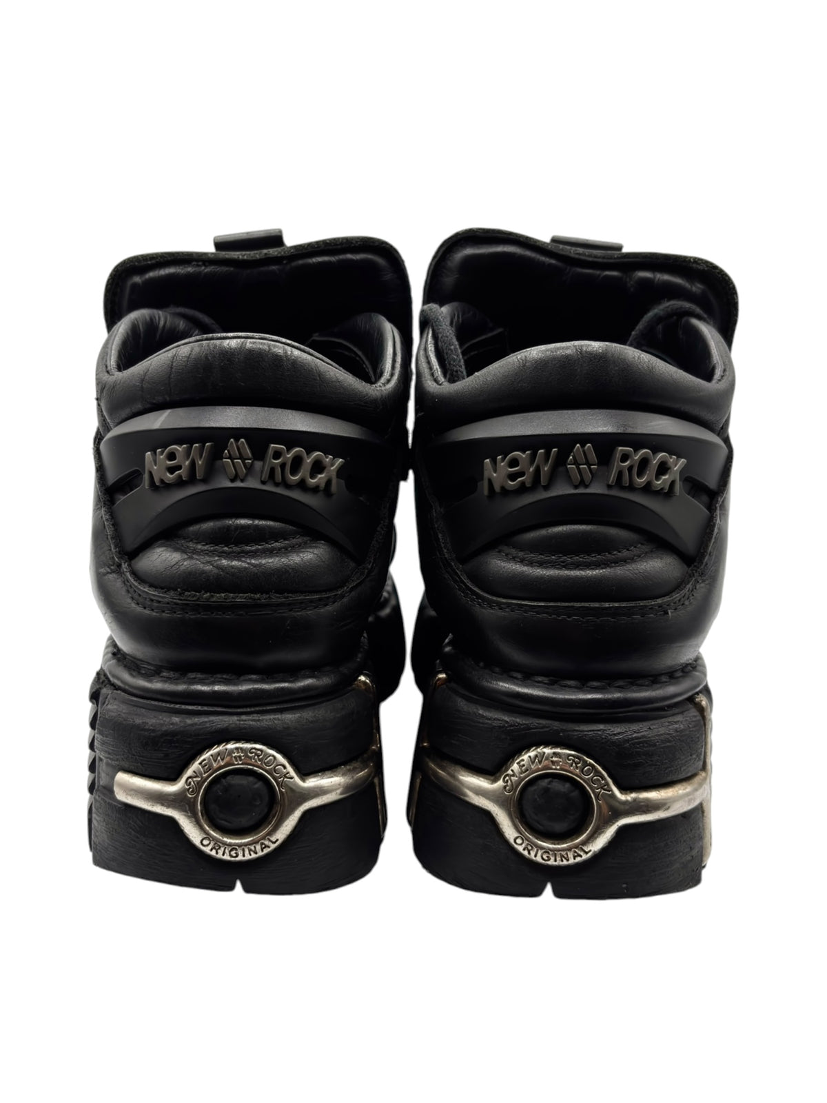 Black platform boots with “New Rock” heel tabs and round metal buckle details