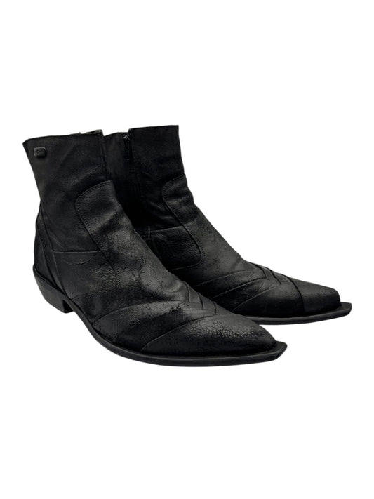 Black leather cowboy boots angled top view showing stitched vamp and low heel.