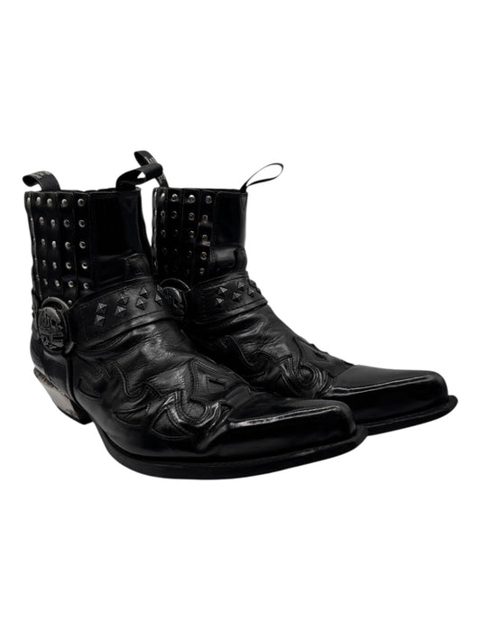 Black cowboy boots angled side view with studded uppers and embossed riding motifs