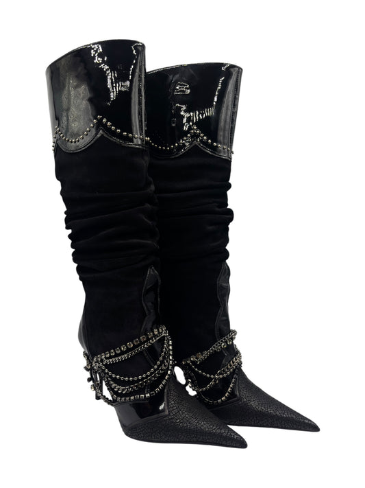 Angled view of black knee-high boots with ruched leg and rhinestone chain adornment