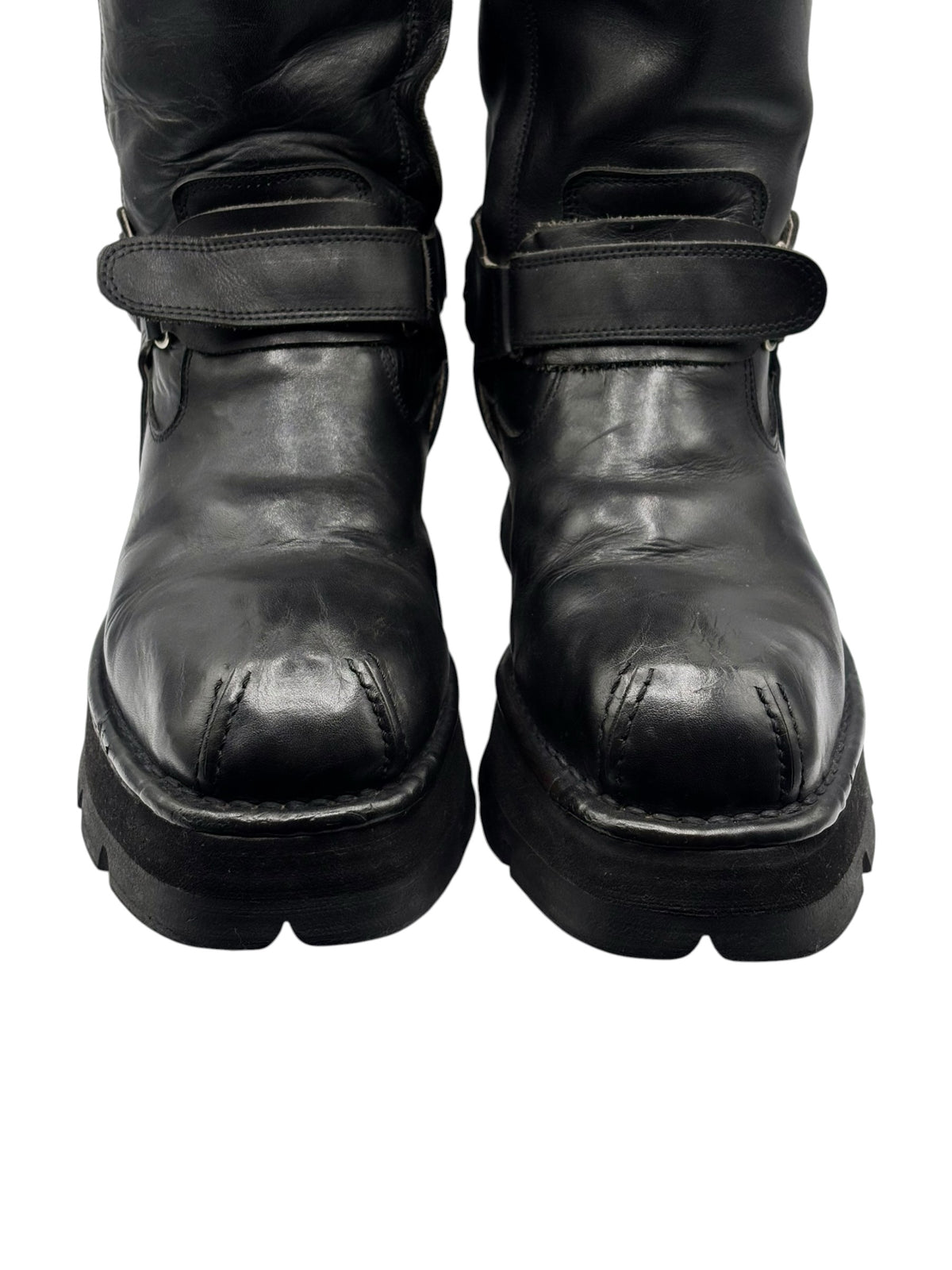Black vintage mid-calf biker boots with low profile sole and worn leather toe caps