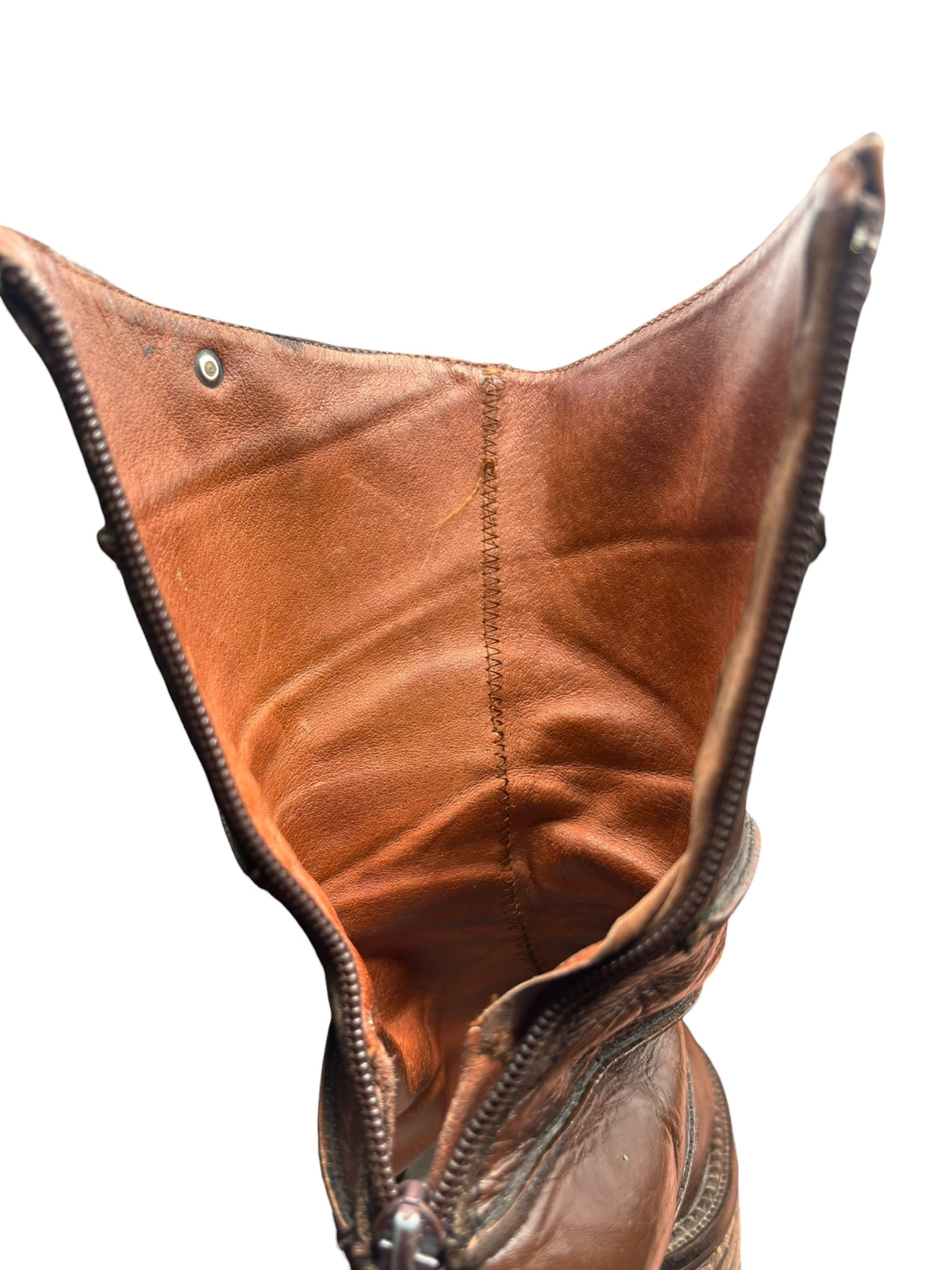 Brown leather mid-calf boot interior opening with visible lining and stitching.