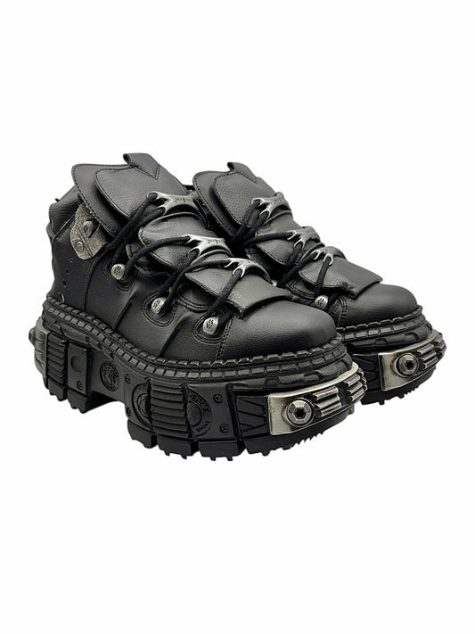 Black lace-up platform boots front view with chunky lug sole and hardware accents