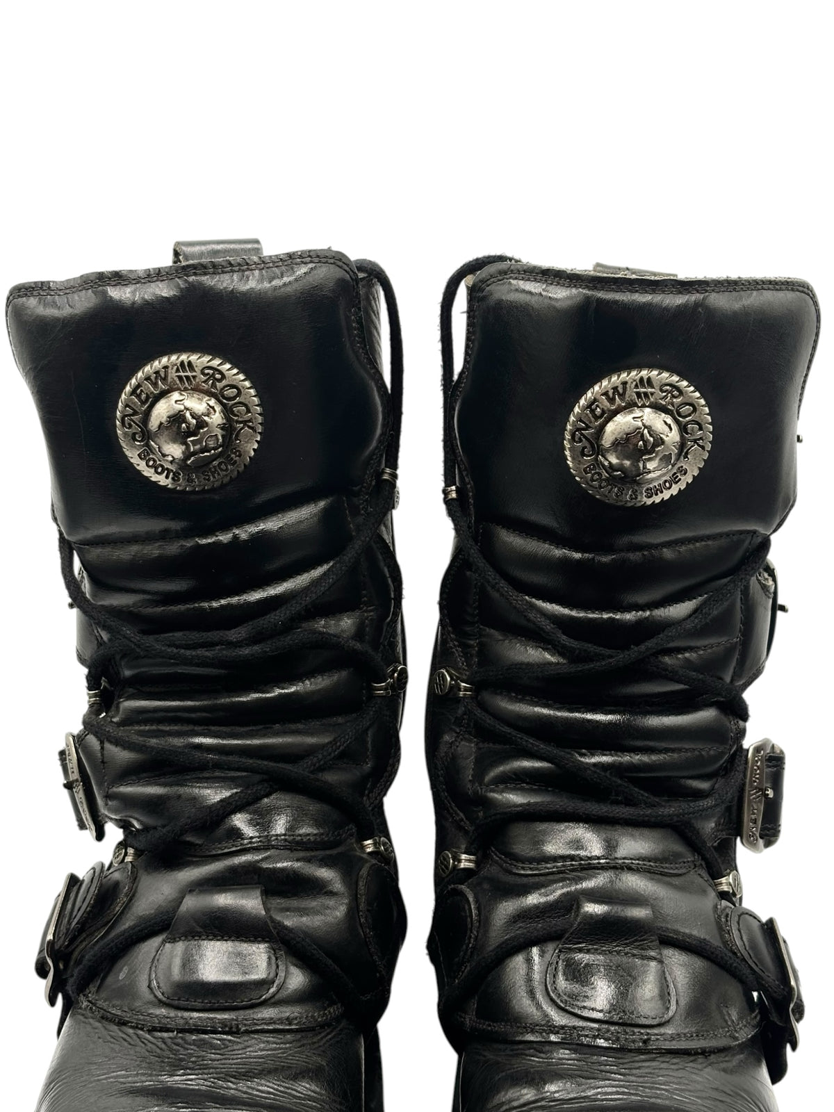 Black mid-calf platform boots front view with coin logos and buckle straps