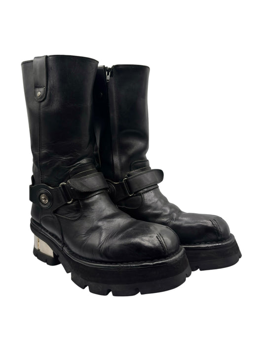 Mid-calf biker boots, black leather, side view with buckle strap and chunky sole.