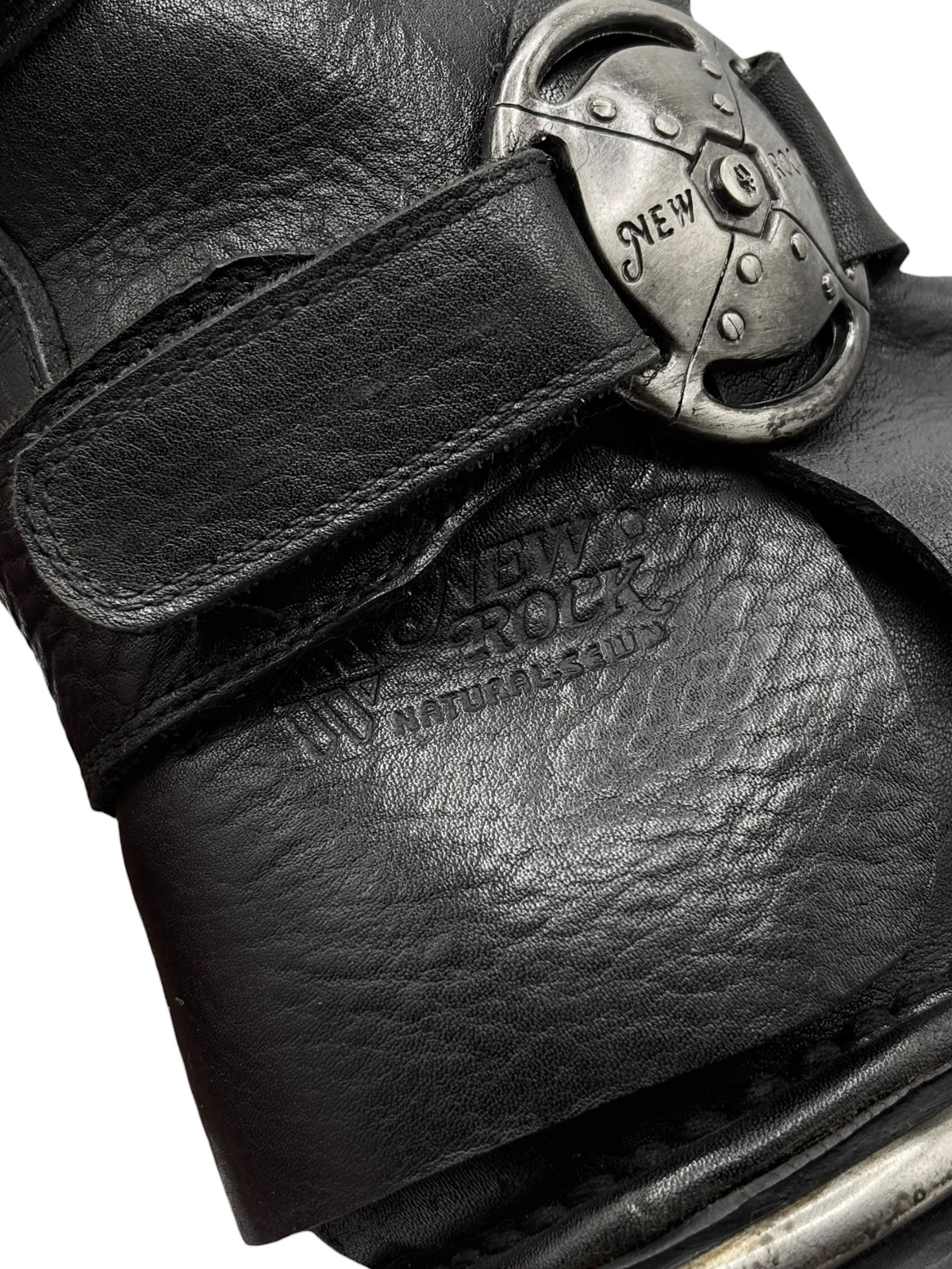 Knee-high leather boots, dark black, with buckled straps and metal plate detail
