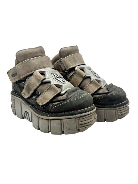 Khaki platform boots with adjustable straps, metal details, and thick rubber sole