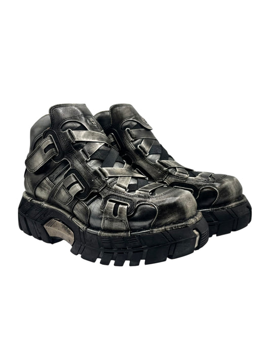 Dark leather mid-calf platform boots with chunky tread and buckled side straps