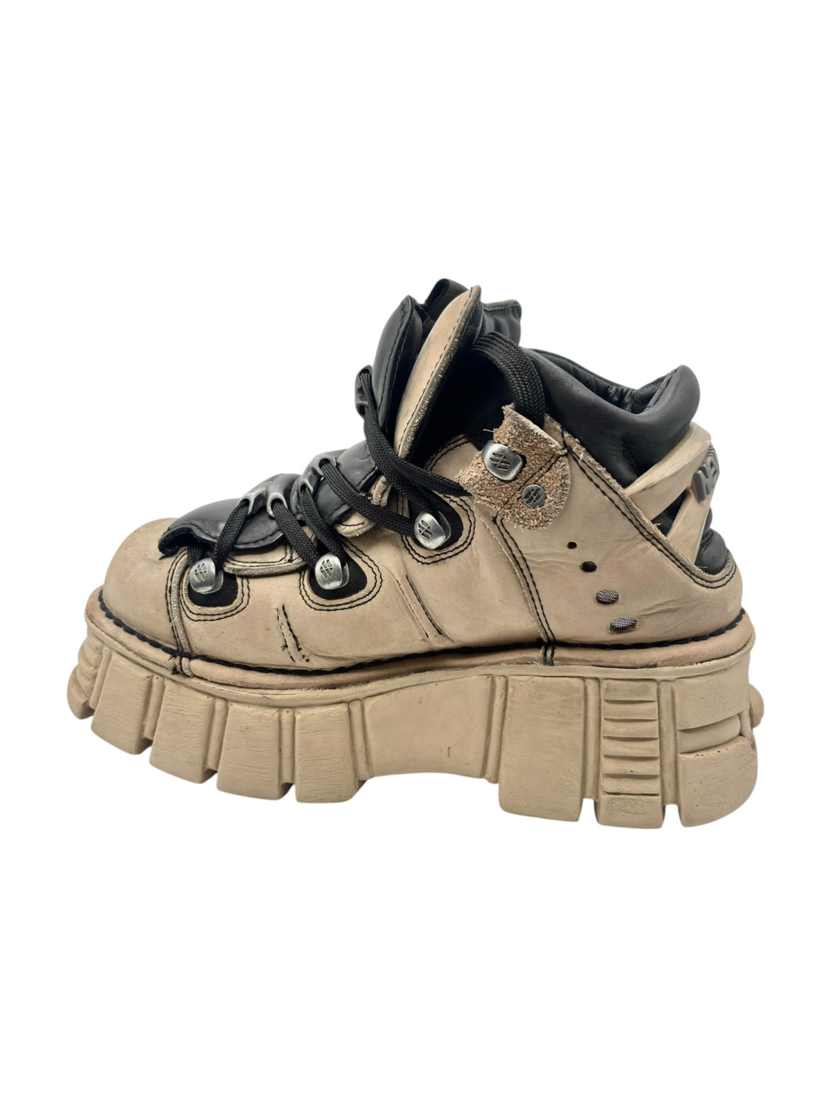 Beige and black platform boots with lace eyelets and thick stacked sole