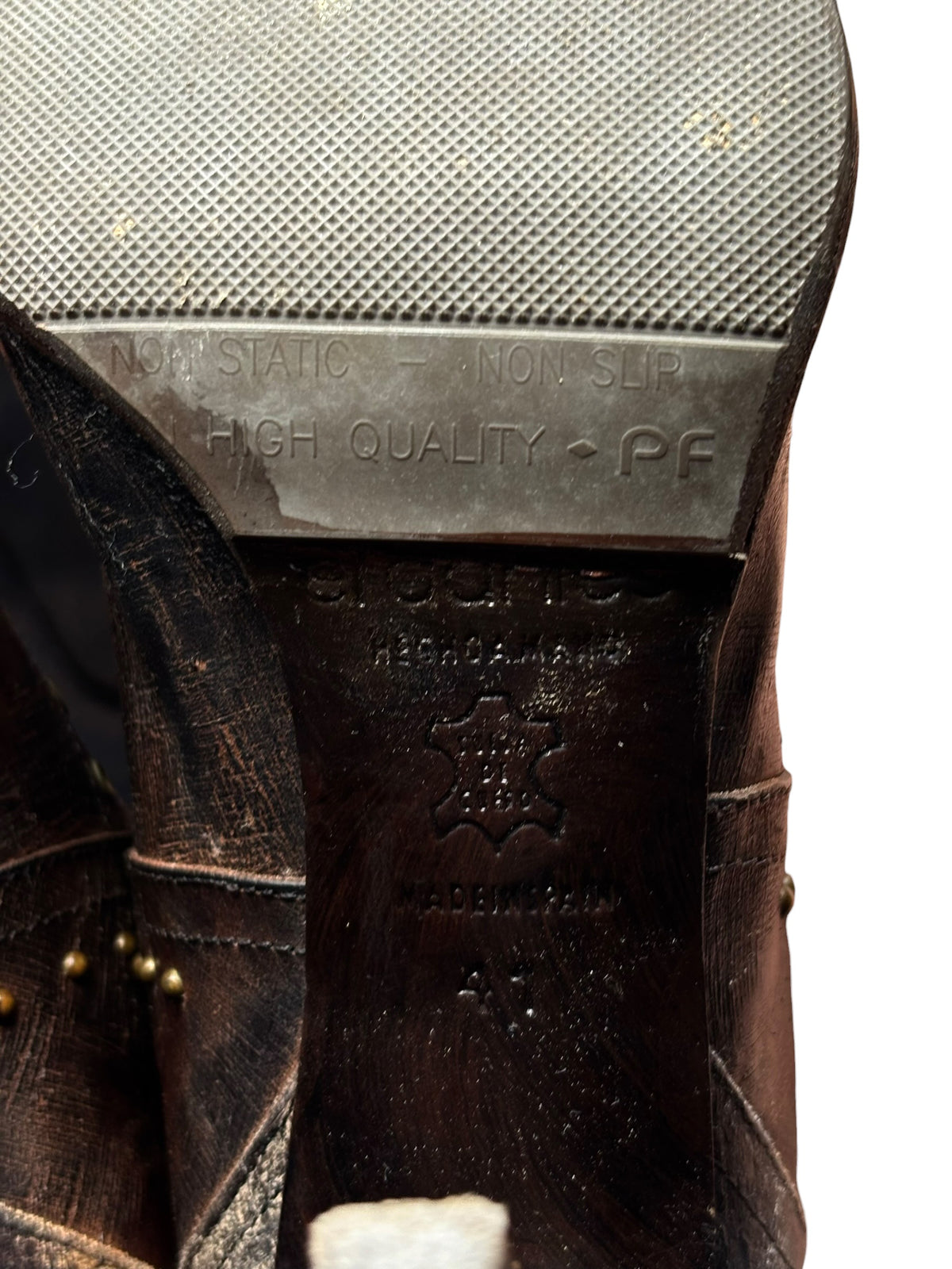 Boot heel and sole close-up with embossed text and non-slip tread pattern