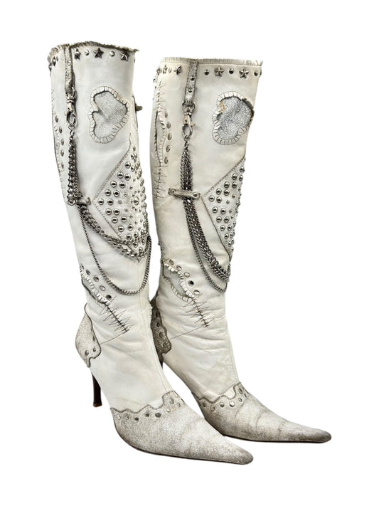 White pointy-toe vintage leather boots with studded trim and side panels
