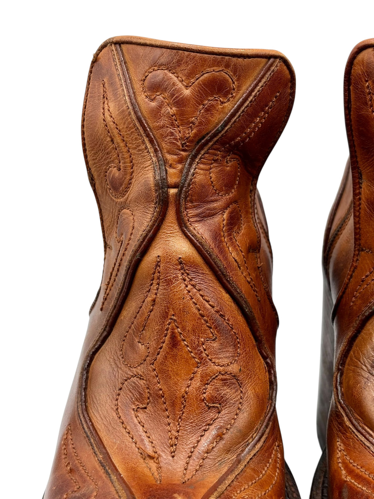 Brown leather platform ankle boots with decorative stitch panels at the shaft