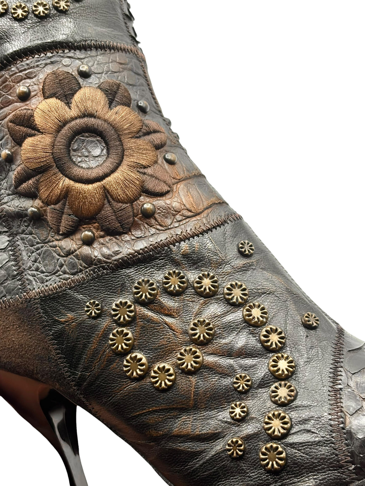 Vintage knee-high leather boots with embossed texture and floral leather applique