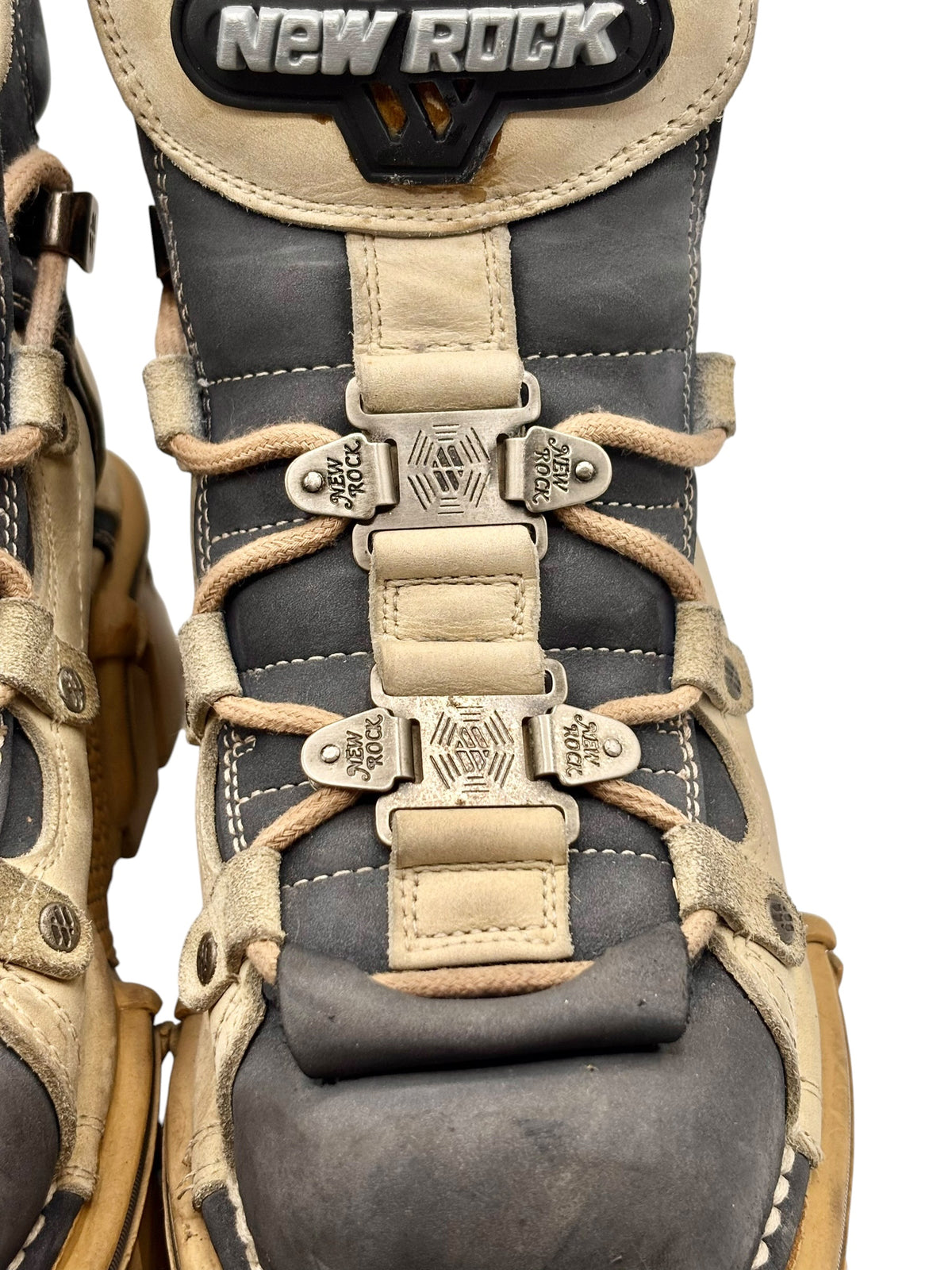 Vintage New Rock boots close-up: lace-up front, buckled straps, and New Rock patch