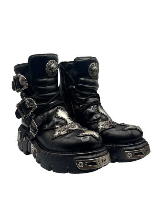 Black leather lace-up platform boots with buckles, cross accents, and thick tread sole