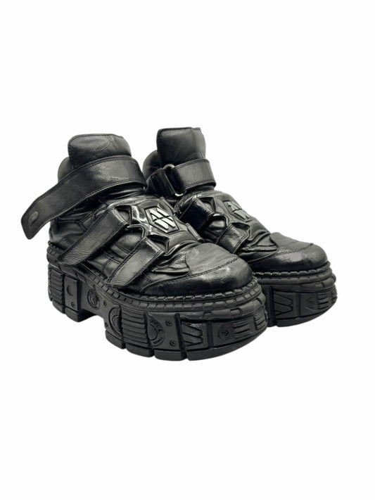 Black techno platform boots side view with buckle straps and raised tread sole