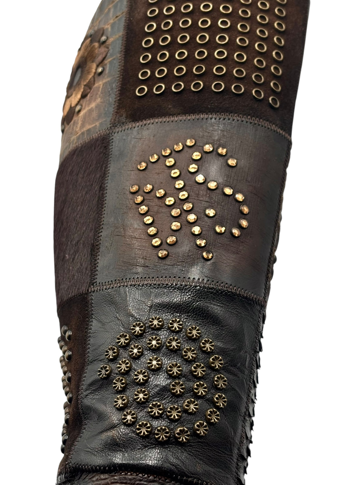 Vintage knee-high leather boots with studded bands, floral patch, and perforated toe panel