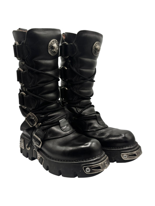 Black knee-high leather boots with buckle straps and chunky lug sole, round toe