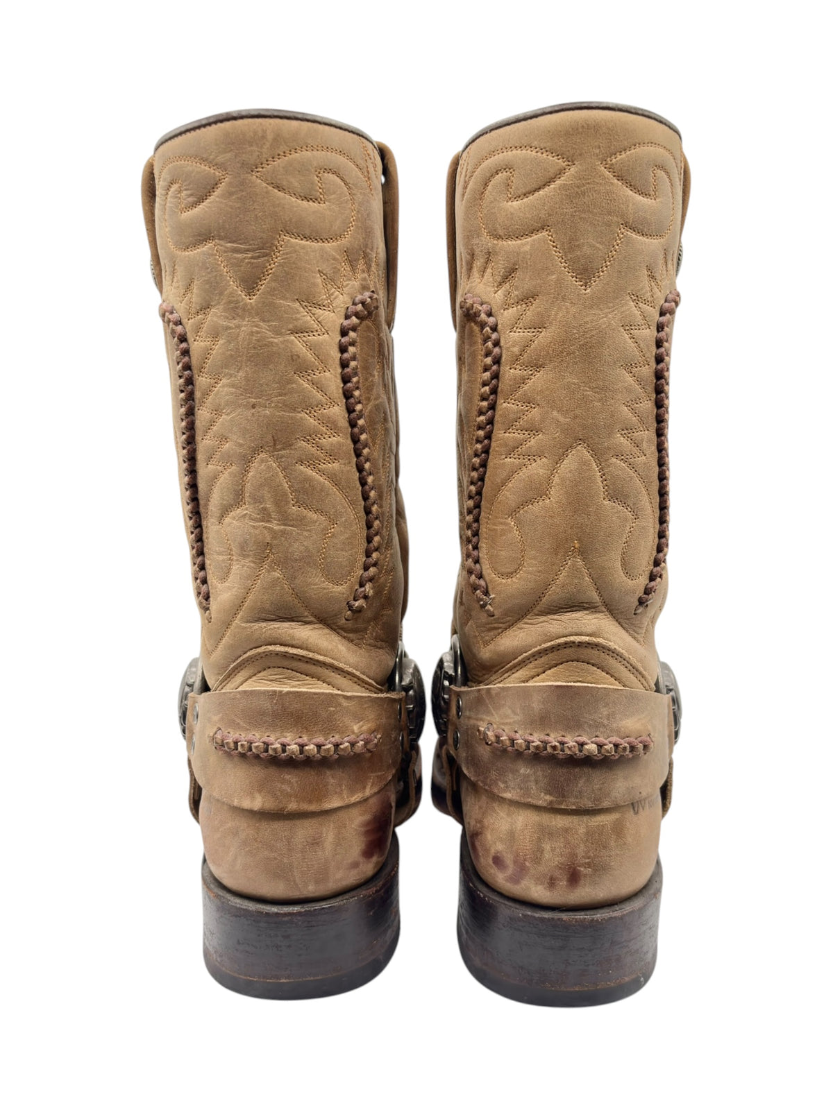 Pair of beige cowboy boots, back view with stitched panels and stacked heels