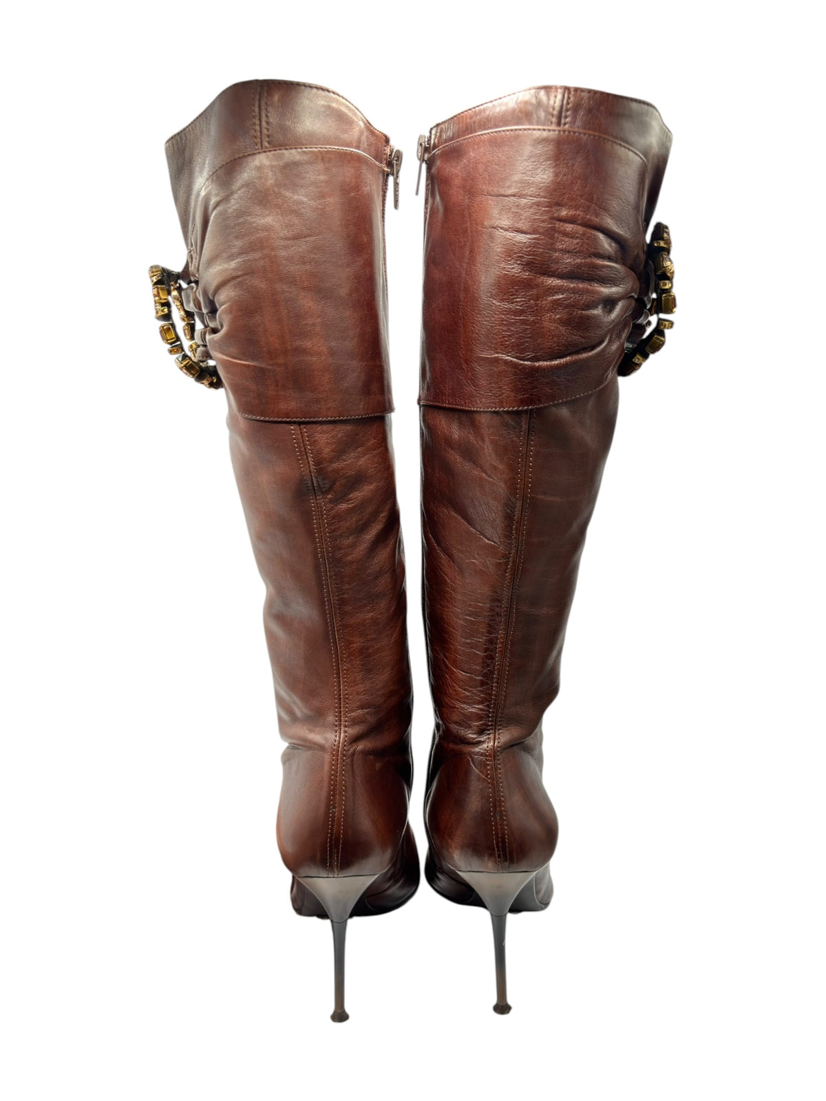 Pair of dark brown leather knee-high boots, back view, with gold-toned cuff embellishments