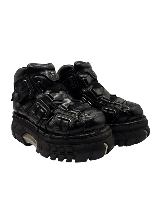 Black leather platform trailer boots with buckled straps and chunky tread sole