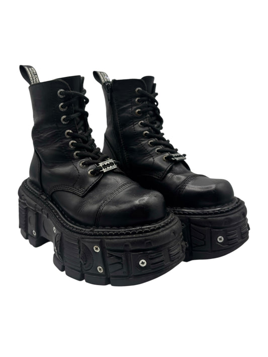 Black lace-up leather platform boots with chunky outsole and metal-studded panels