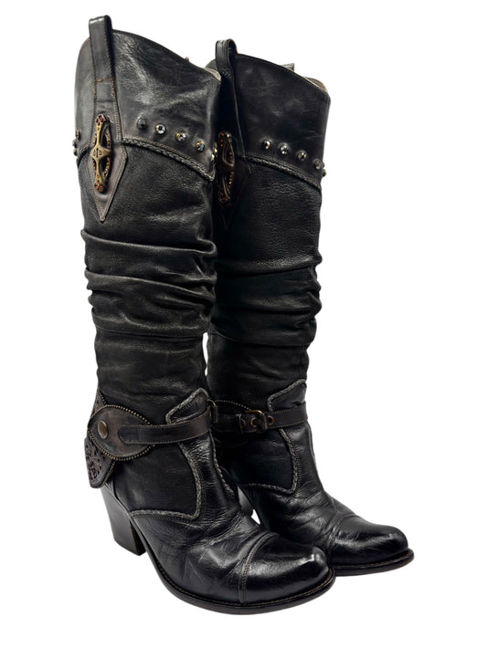 Black knee-high leather boots with buckled straps and stacked heel