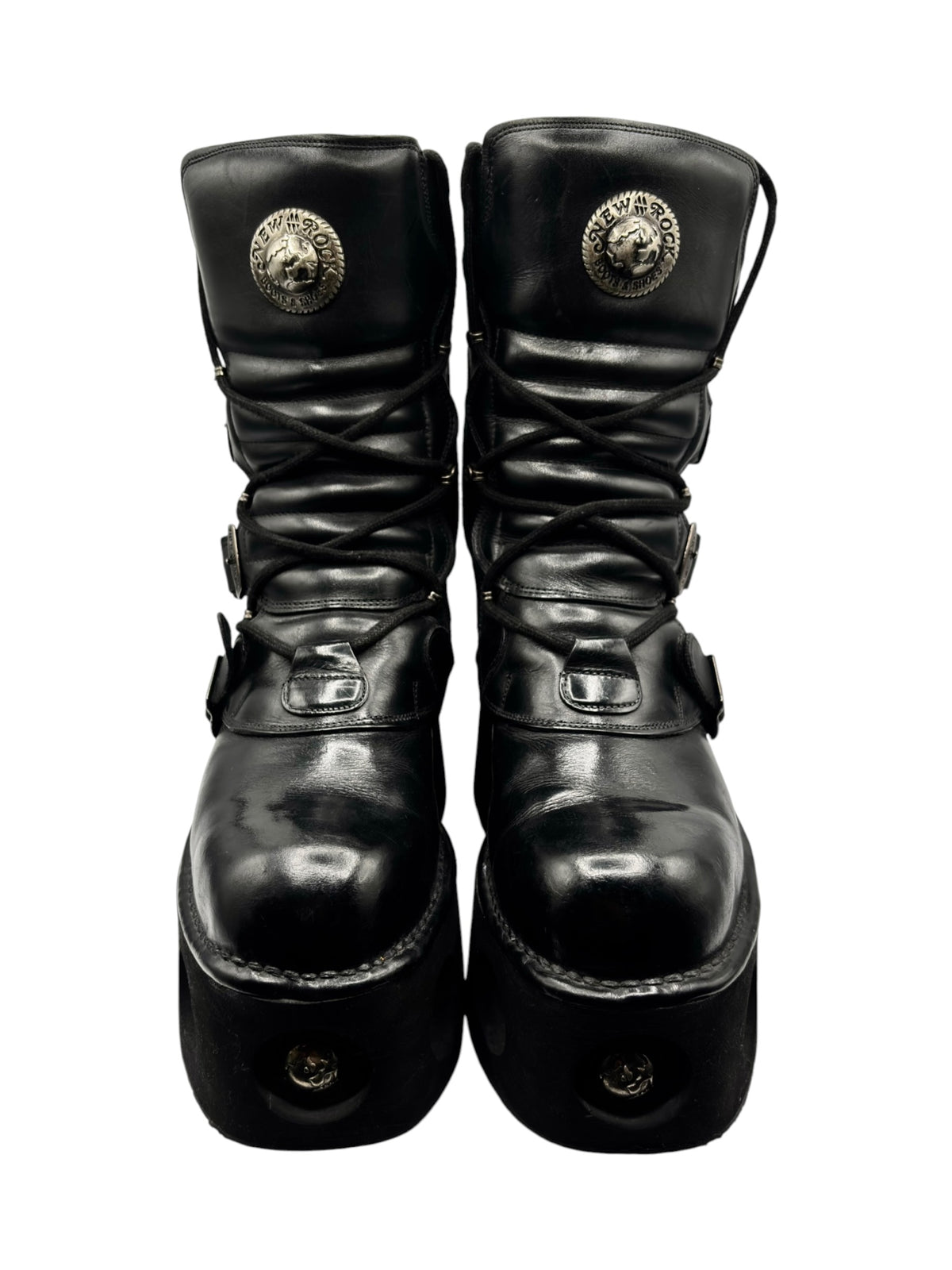Top view of vintage black platform boots with lace-up and gold-toned emblem hardware